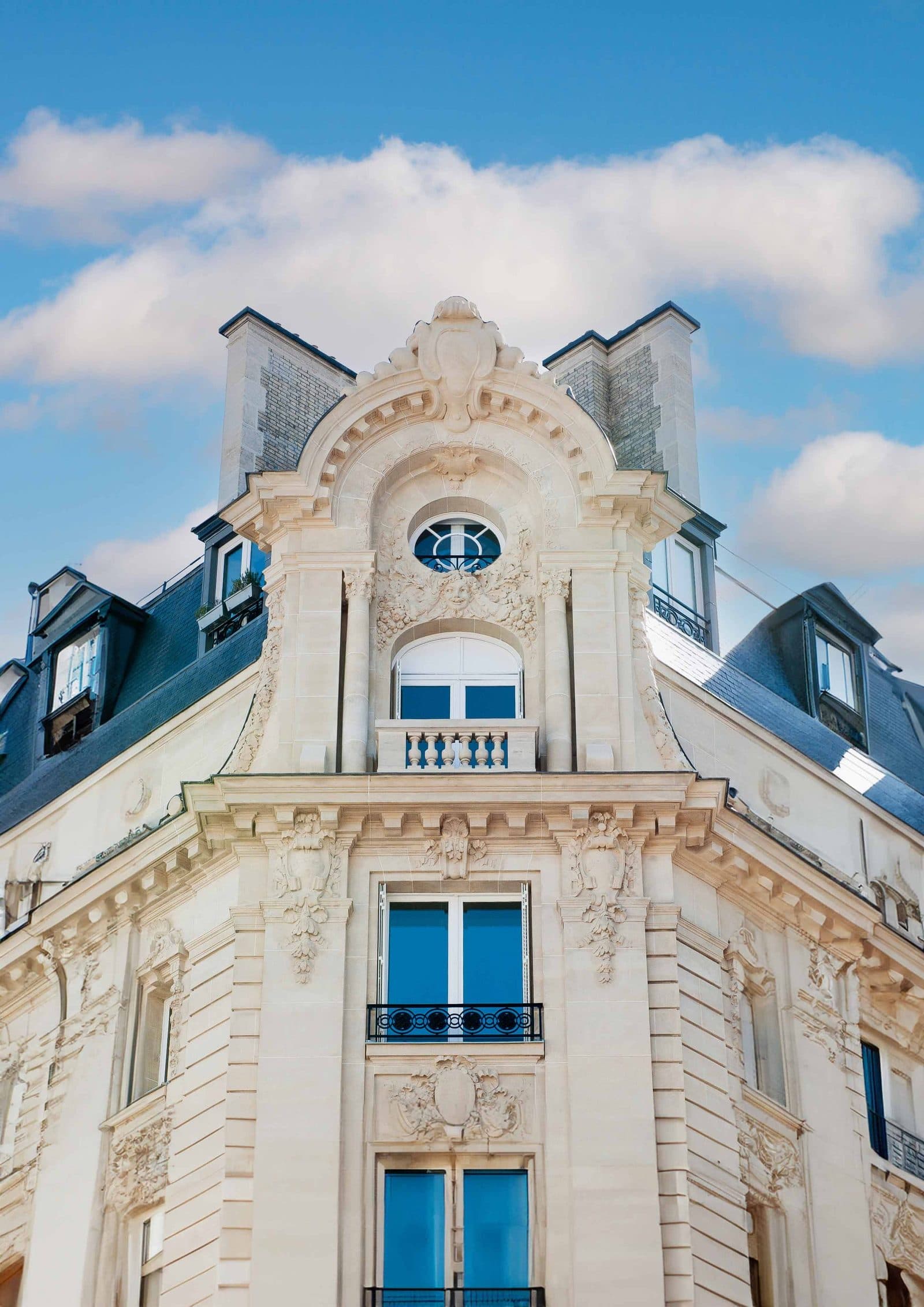 Façade d'immeuble haussmannien rénové à Clichy, couverture et ornements en pierre par Aux Compagnons Parisiens